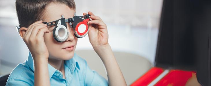 featured image used for the blog post, understanding vision impairment. It's a young boy during an eye exam.