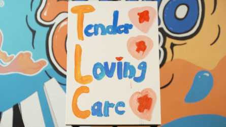 an image of tender loving care's signage